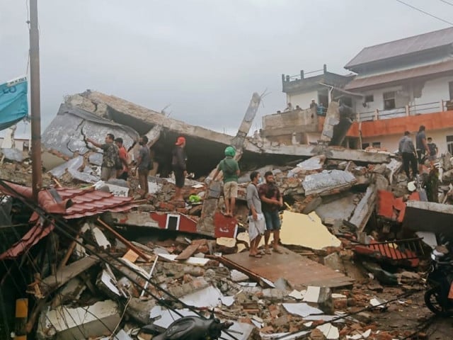 residents inspect buildings damaged by earthquake in mamuju west sulawesi indonesia photo ap